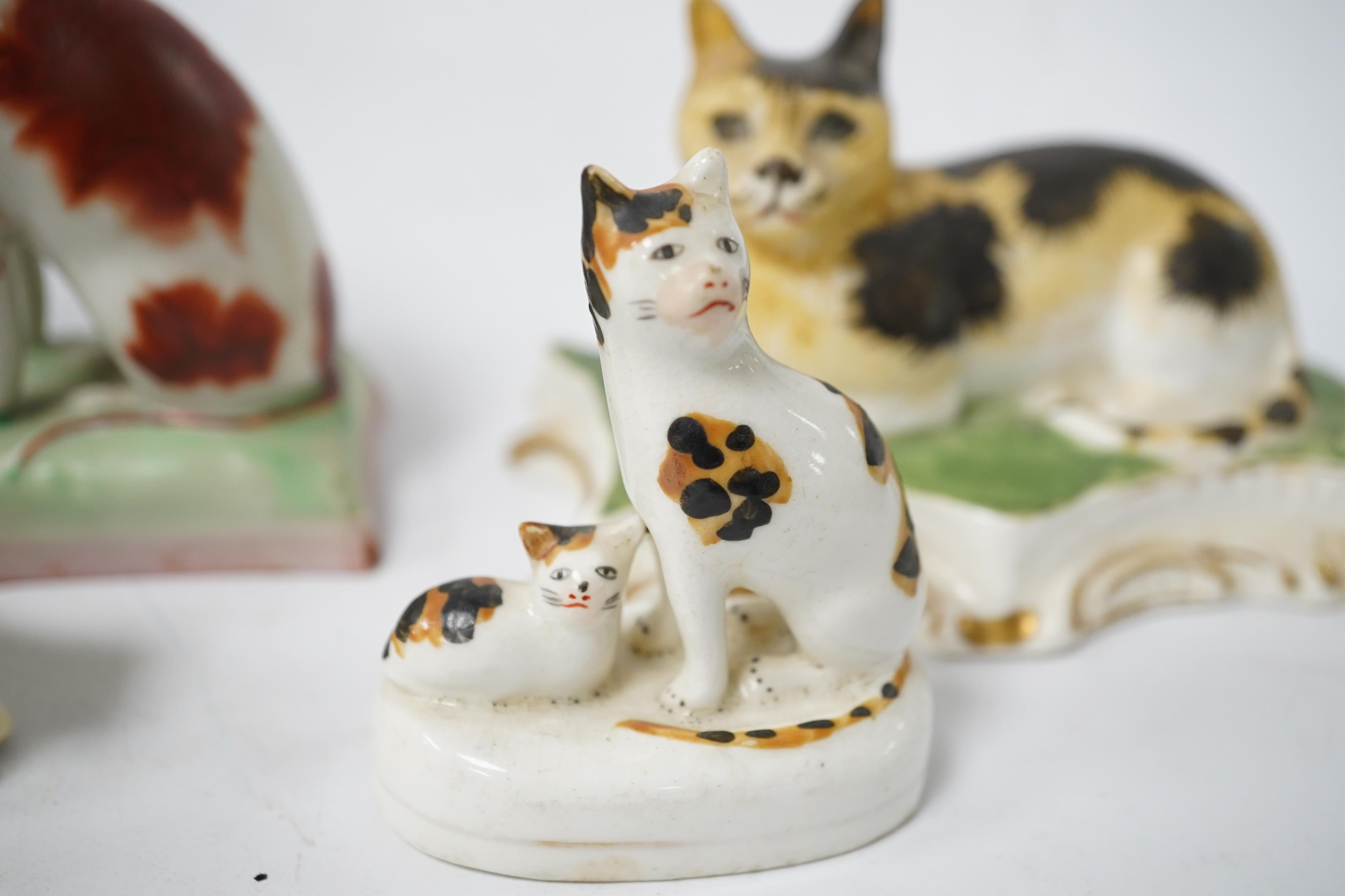 Five rare Staffordshire porcelain models of cats, circa 1830-50, including a group of a cat and kitten, together with a pair of late Staffordshire porcellaneous cats, Condition - restoration to three of the cats and a cr